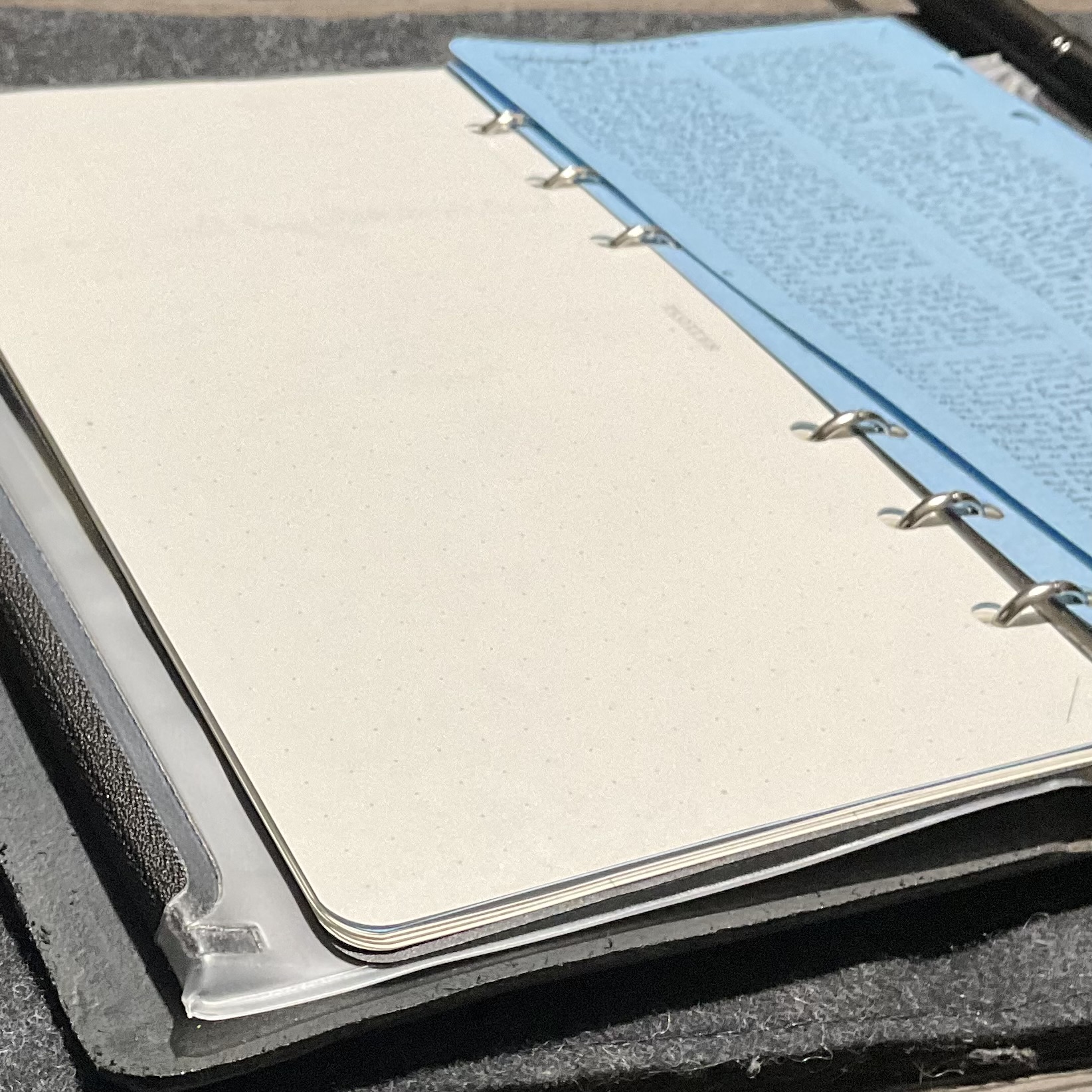 Open binder with loose notebook page. 